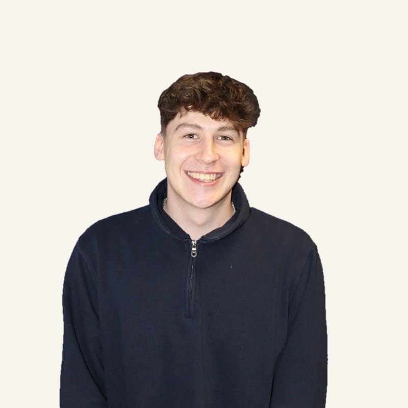 Steven, who runs Job Done Websites, smiling in a navy zip-neck jumper